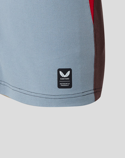 Close-up of a gray athletic shirt with a brand logo on a light gray background