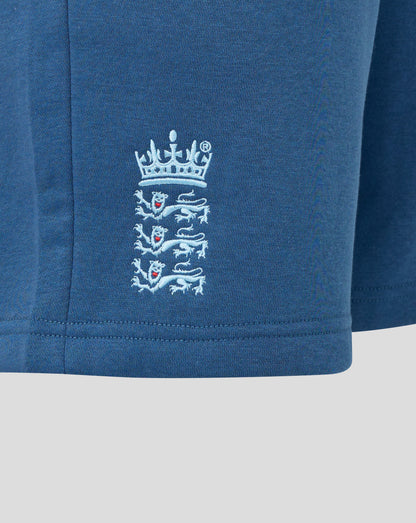 Close-up of a blue garment with a white embroidered logo on a light gray background