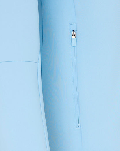 Close-up of a light blue jacket with a zipper detail on a white background