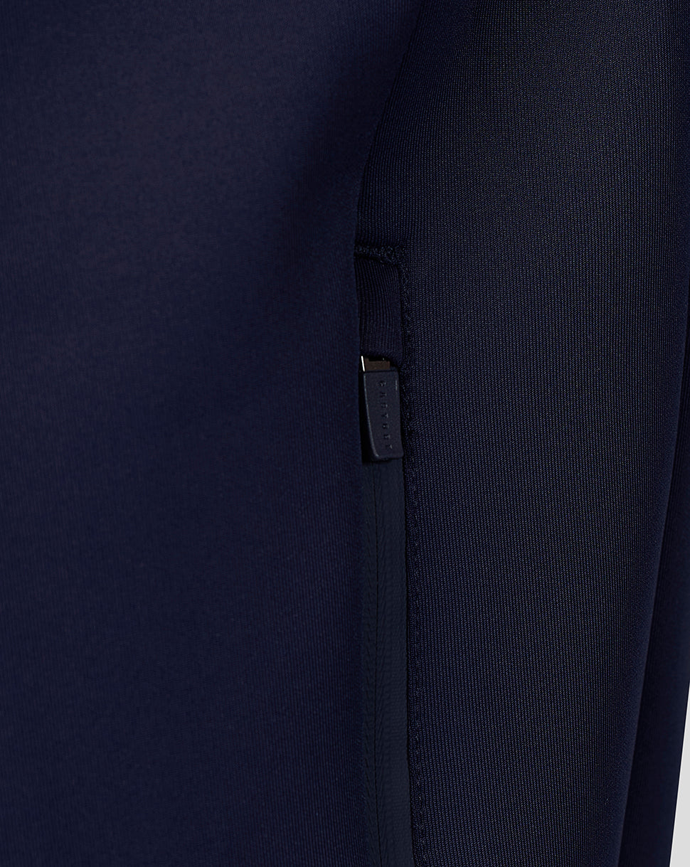Close-up of navy Travel Flex Hoodie chest showing Breedon logo and tiger emblem