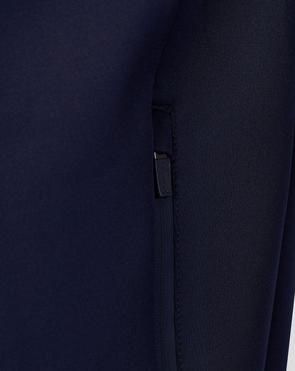 Close-up of navy Travel Flex Hoodie chest showing Breedon logo and tiger emblem