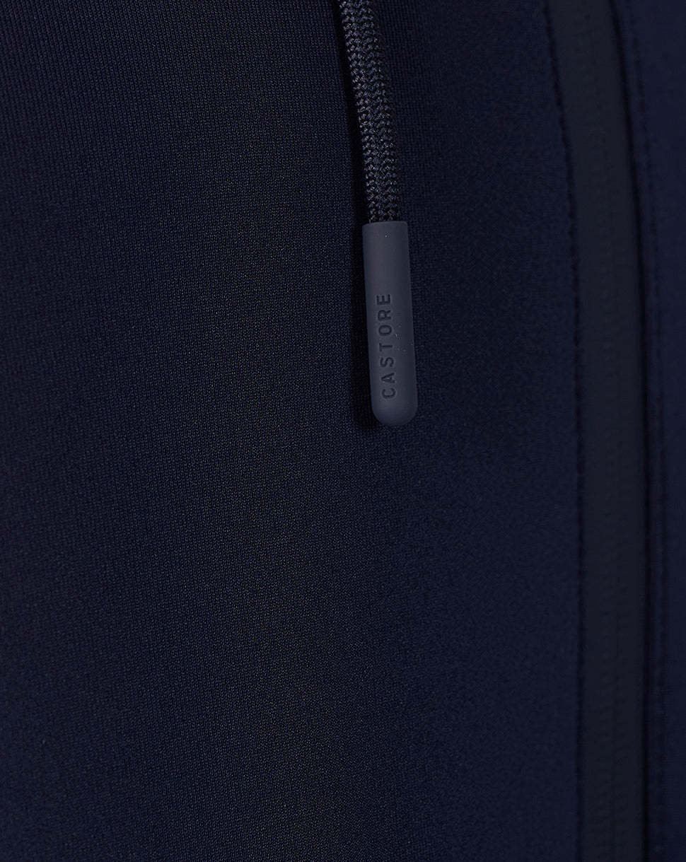 Close-up of navy Travel Flex Hoodie zipper area with Castore branded pull tab