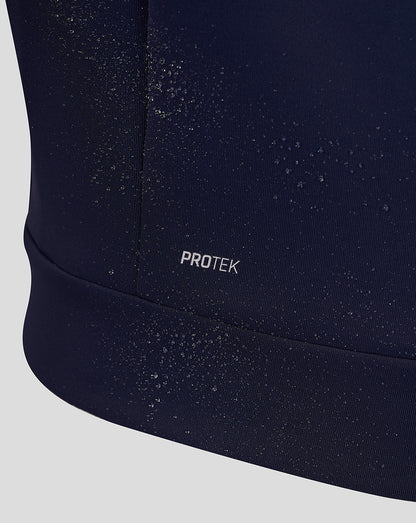 Close up of navy Travel Hoodie fabric showing water beads and the Protek branding at the hem.