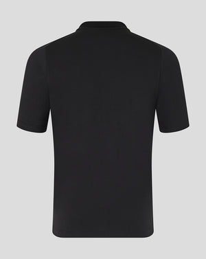 Black polo shirt on a light gray background