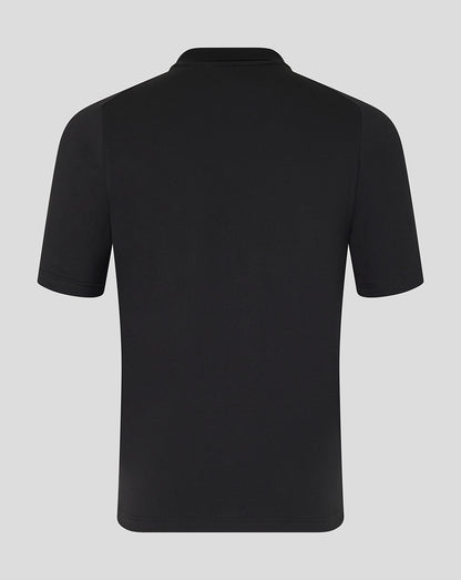 Black polo shirt on a light gray background