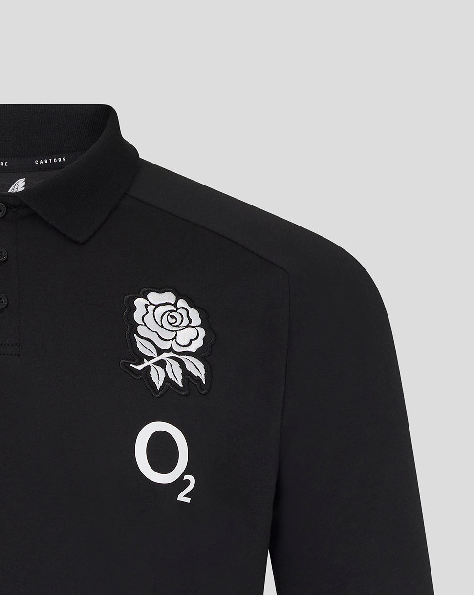 Black polo shirt with a rose emblem and 'O2' logo on a light gray background