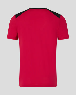 Red t-shirt with black shoulders on a gray background