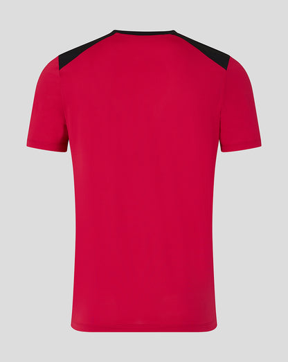 Red t-shirt with black shoulders on a gray background