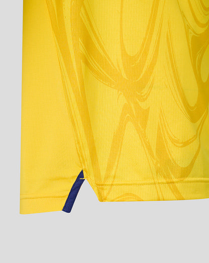 Close-up of a yellow garment with a blue zipper on a light gray background