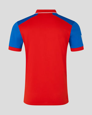 Red polo shirt with blue sleeves on a gray background