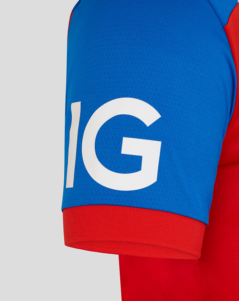 Close-up of a red and blue sleeve with a large white 'IG' logo on a gray background