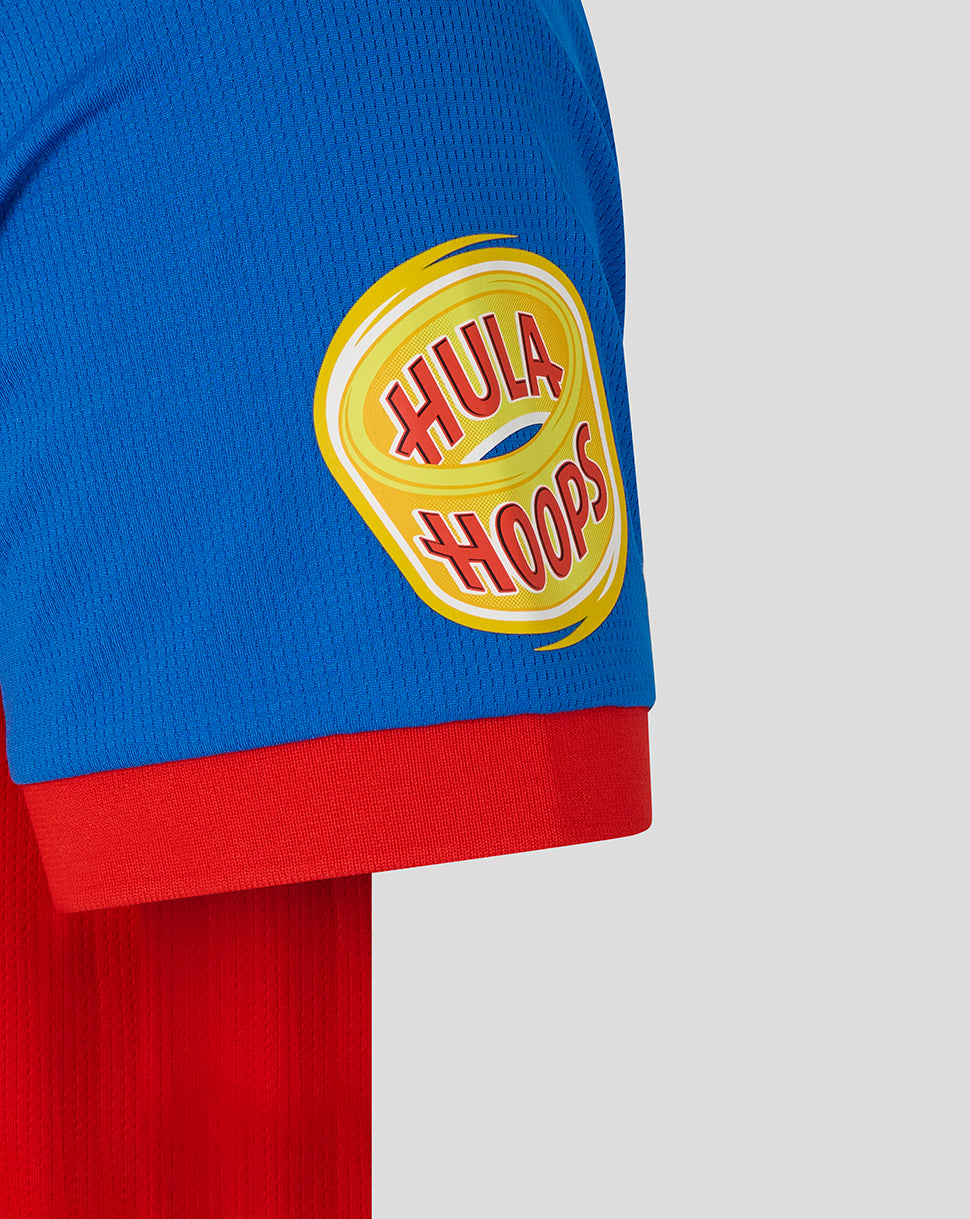 Close-up of a blue and red garment with a Hula Hoops logo on a gray background