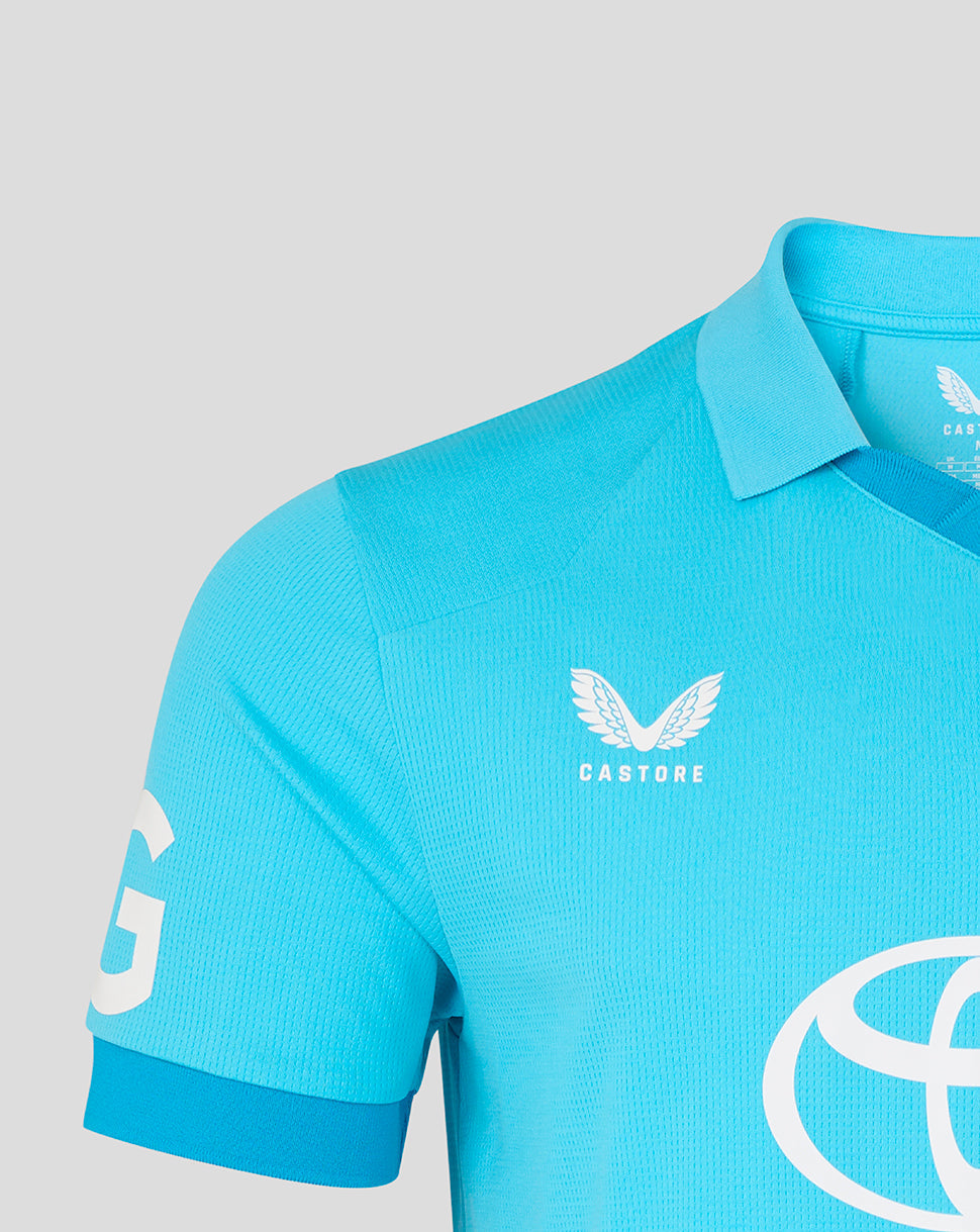 Blue polo shirt with white branding on a light gray background