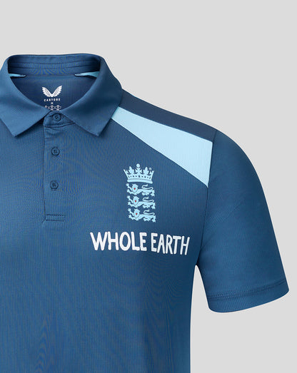 Blue polo shirt with 'Whole Earth' branding on a gray background