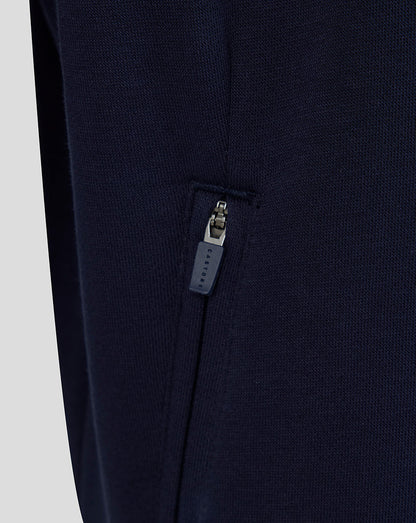Navy blue pants with a zipper detail on a light gray background