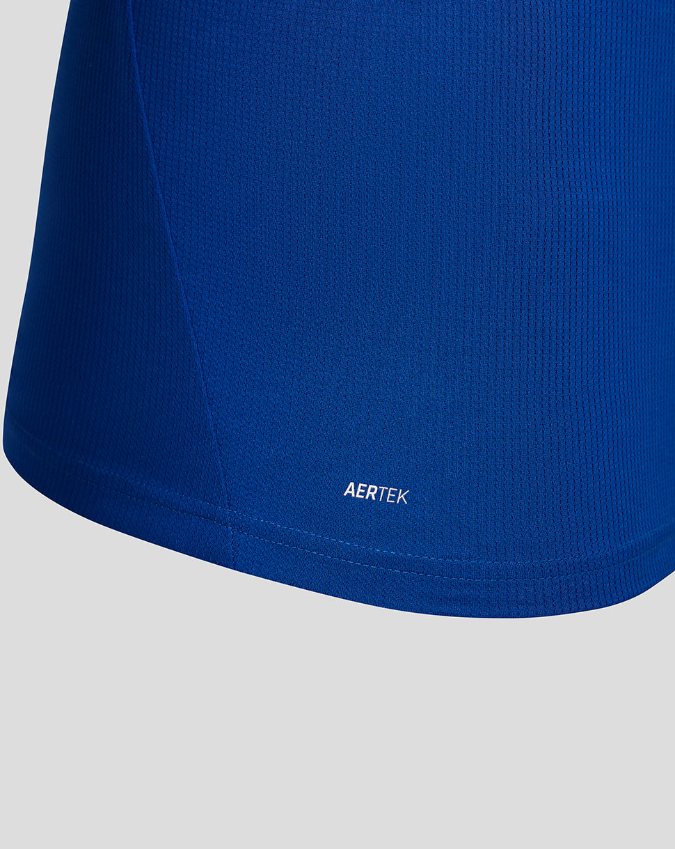 Close-up of a blue garment with 'AERTEK' branding on a light gray background