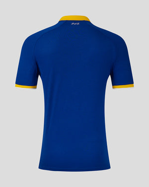 Blue polo shirt with yellow accents on a gray background