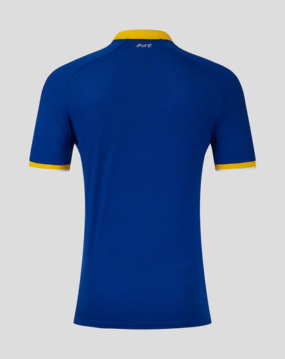 Blue polo shirt with yellow accents on a gray background