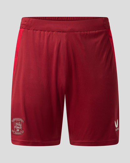 Red athletic shorts with a white club crest on the left leg and a white logo on the right leg, displayed against a light gray background.