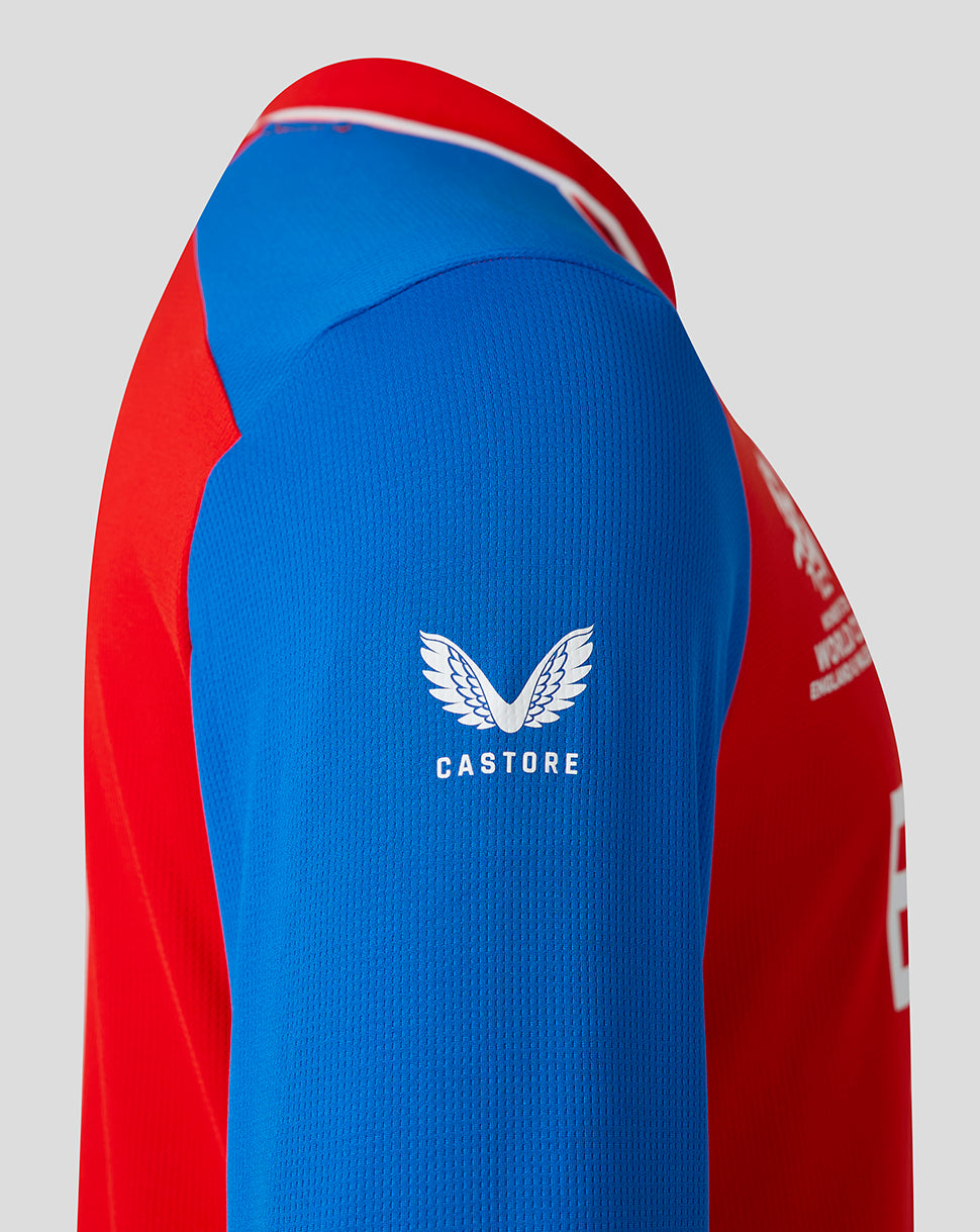 Red and blue sports jersey with Castore logo on a gray background
