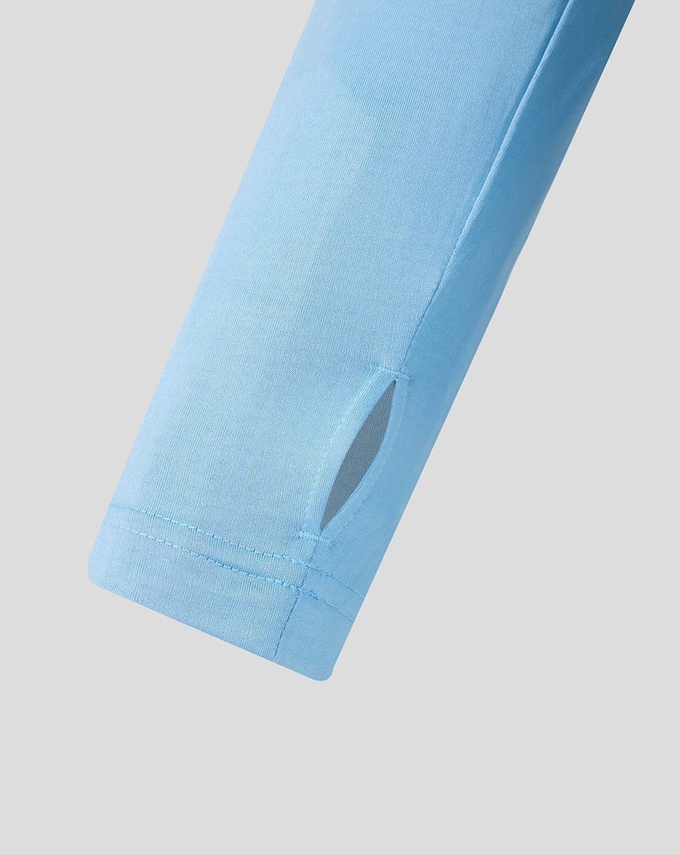 Close-up of a light blue sleeve on a plain background