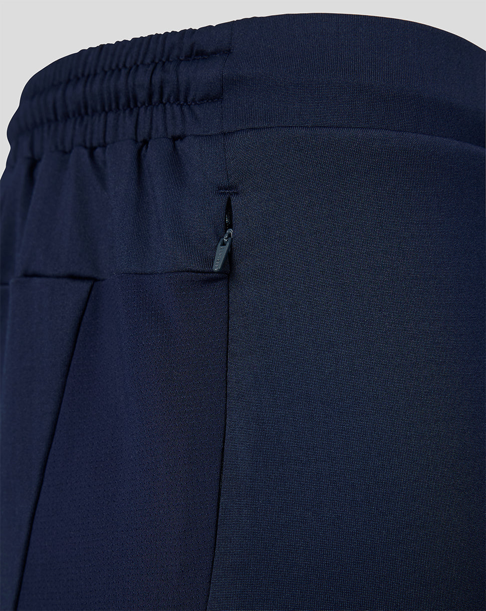 Navy blue pants with an elastic waistband on a light gray background