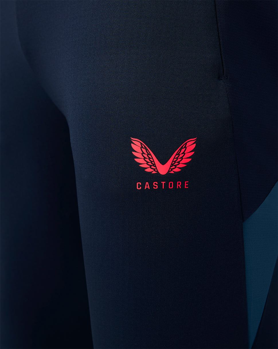 Navy blue joggers with a red Castore logo on a dark background