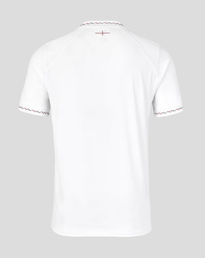 White t-shirt with decorative trim on a light gray background