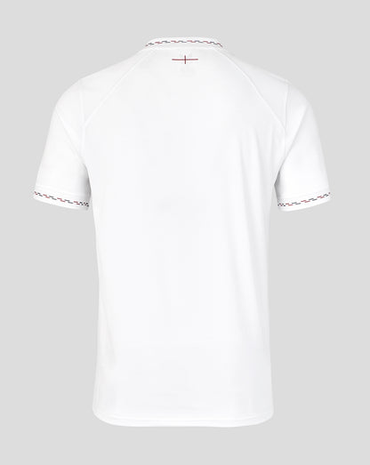White t-shirt with decorative trim on a light gray background