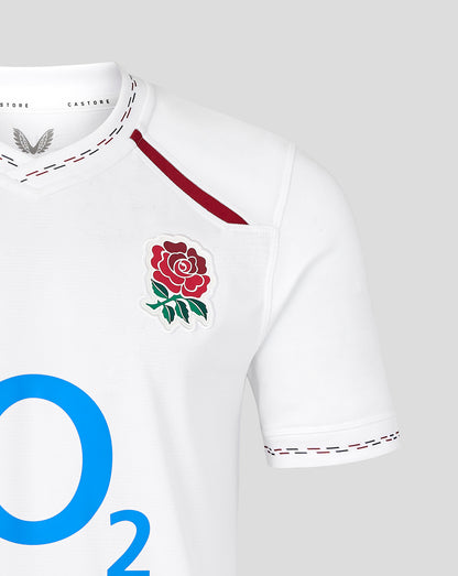 White sports jersey with a red rose emblem and 'O2' branding on a gray background