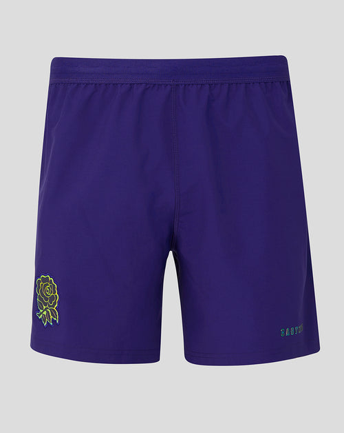 Purple shorts with a green logo on a gray background