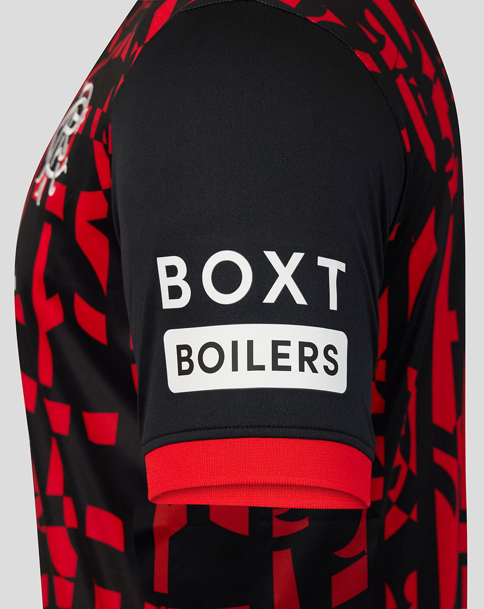 Close-up of the back of a black and red patterned sports jersey with a white BOXT BOILERS sponsor logo on the upper back.