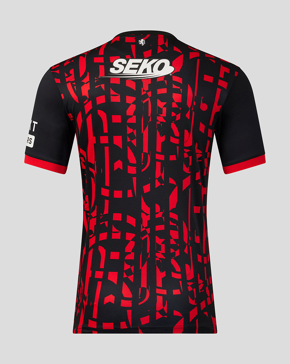 A football jersey shown from the back, featuring a black base with a bold red abstract geometric pattern, a white SEKO logo on the upper back, and a white sponsor logo on the right sleeve, set against a solid gray background.