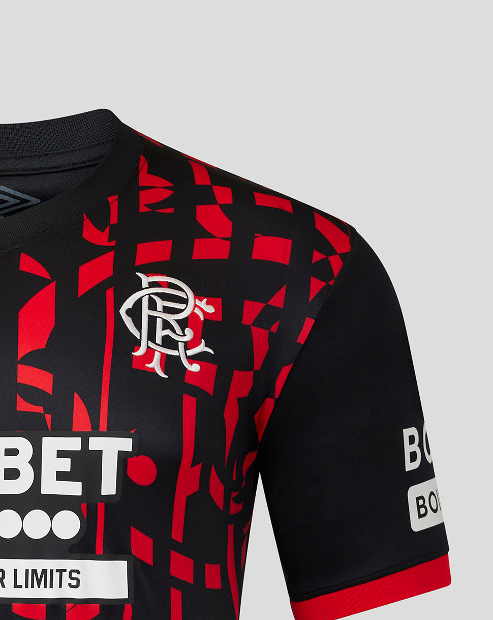 Close-up of a Rangers jersey with a black and red geometric pattern, featuring the white club crest on the chest and sponsor logos on the sleeves.