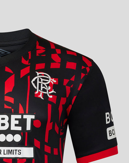 Close-up of a Rangers jersey with a black and red geometric pattern, featuring the white club crest on the chest and sponsor logos on the sleeves.