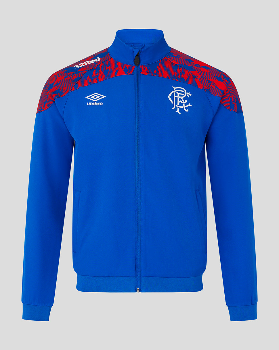 A royal blue track jacket with red patterned shoulder panels, featuring the Umbro logo and Rangers FC crest on the chest, displayed against a neutral gray background.