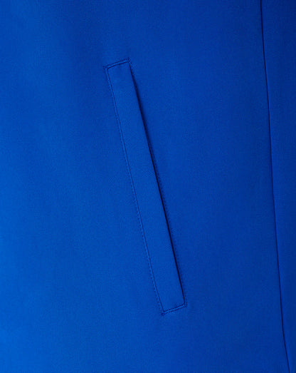 A close-up of a bright royal blue fabric surface with a vertical welt pocket stitched into it.