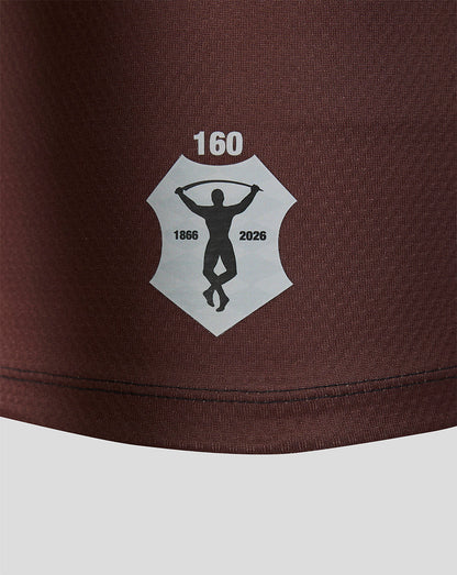 Brown shorts with a logo featuring a silhouette and text on a white background