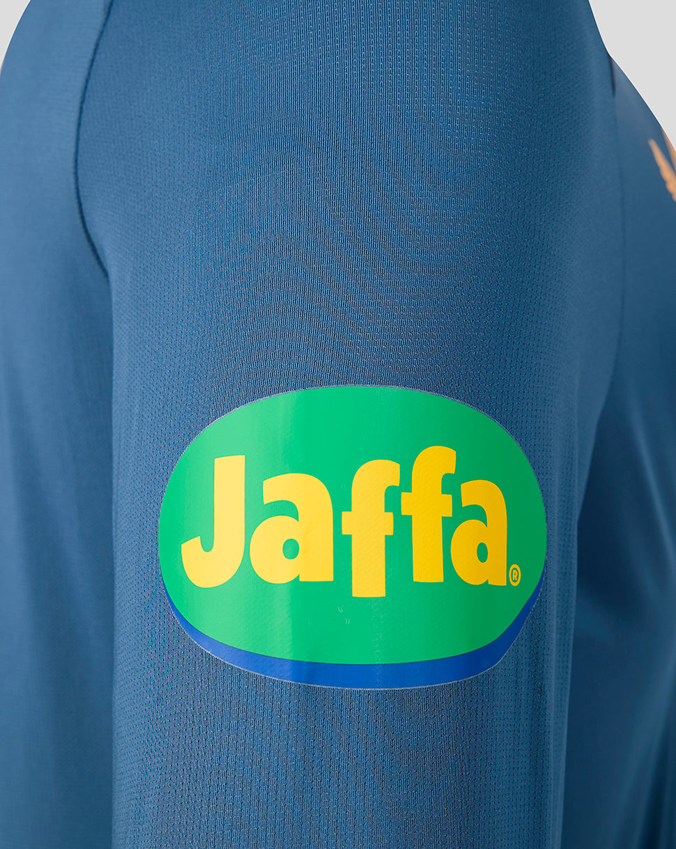 Close up of blue Leicester Tigers training long sleeve top showing a green Jaffa sponsor patch on the sleeve