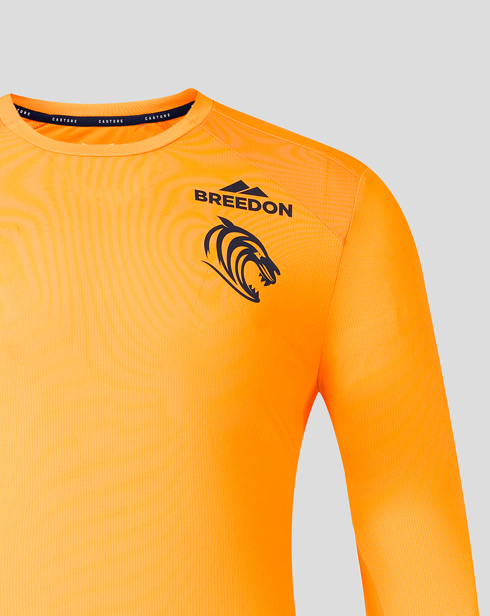 Bright orange long-sleeve athletic jersey with a black BREEDON logo and tiger head graphic on the chest, shown against a light gray background.