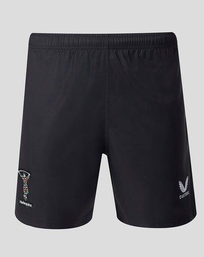 Black shorts with brand logos on a light gray background