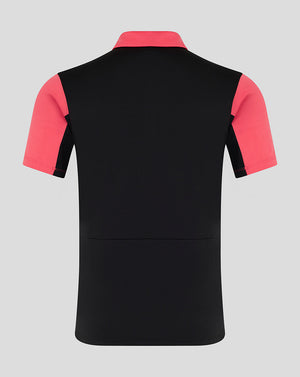 Black polo shirt with pink sleeves on a gray background