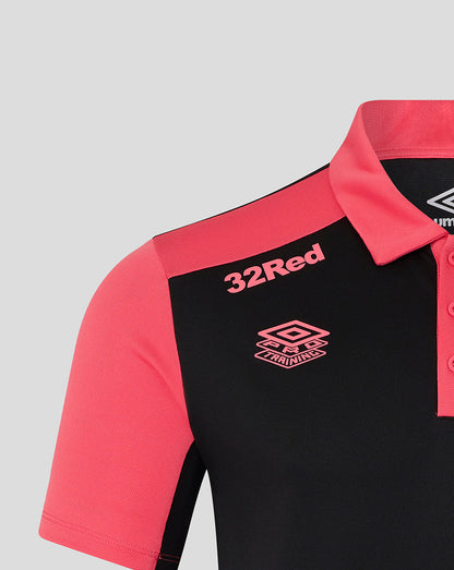 Black and pink polo shirt with '32Red' and Umbro logos on a gray background