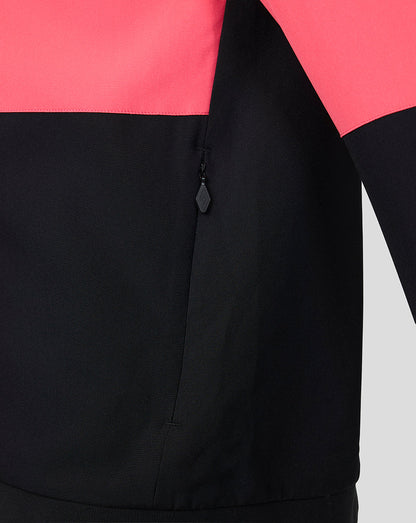 Close-up of a black jacket with pink and black color block design.