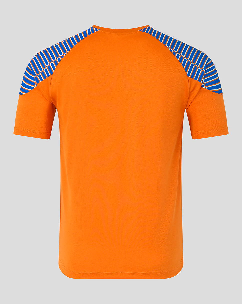 An orange short-sleeve athletic t-shirt with blue and white patterned raglan shoulder panels, shown against a solid gray background.