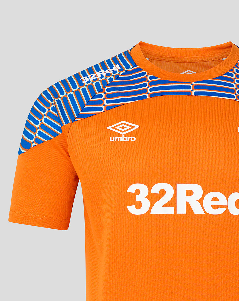 Close-up of an orange football jersey with blue patterned shoulder panels, a white Umbro logo, and a large white 32Recor sponsor logo on a light gray background.