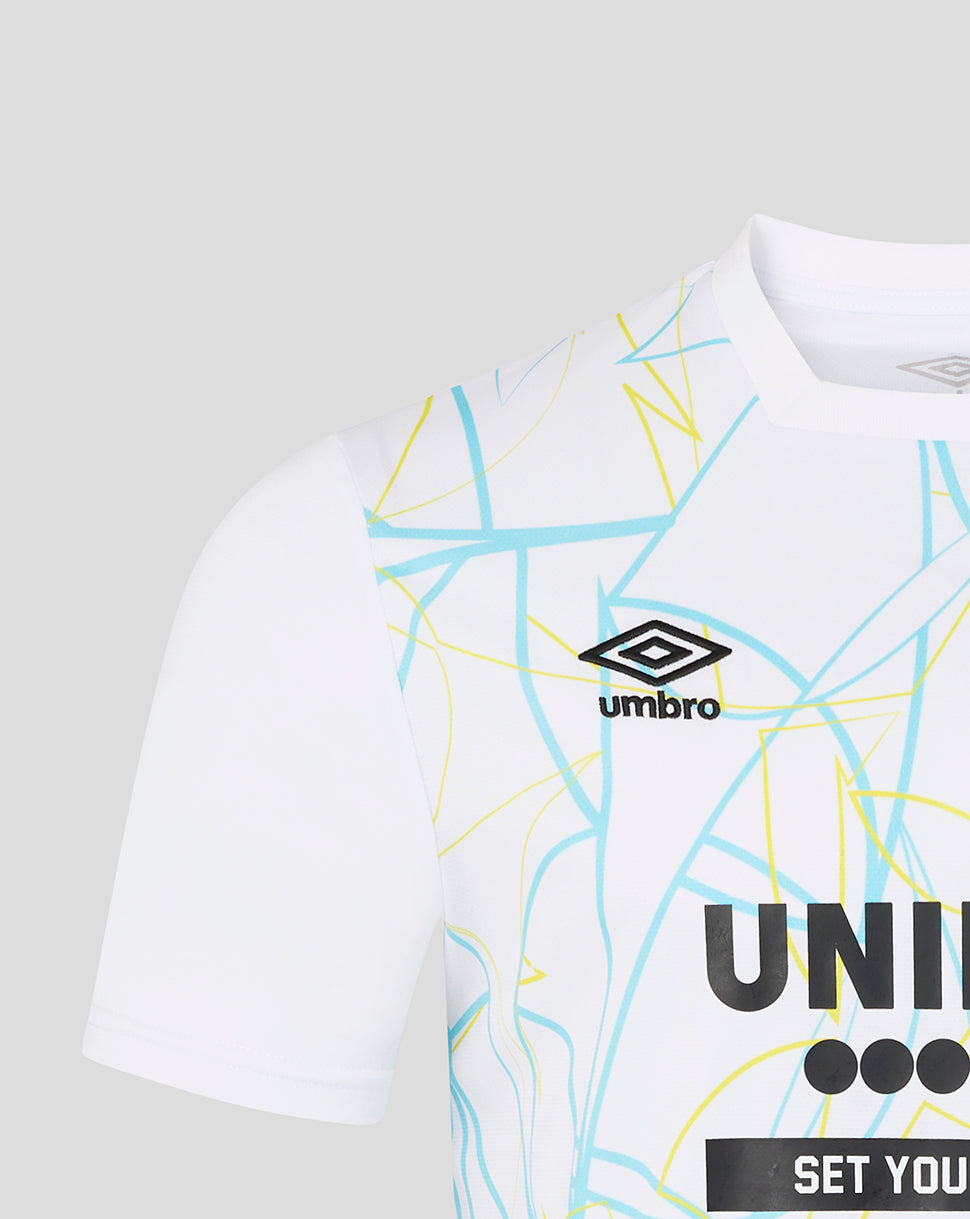 White t-shirt with geometric patterns and Umbro logo on a light gray background