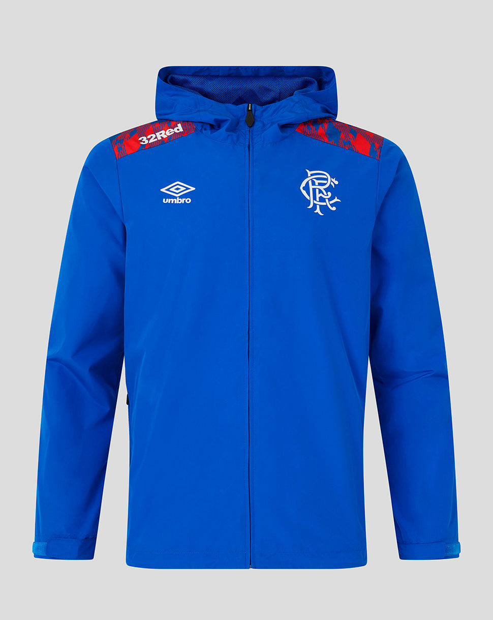 A royal blue hooded zip-up jacket featuring the white Umbro logo on the right chest and the Rangers FC crest on the left chest, with red patterned shoulder panels and '32red' text on the right shoulder, shown against a solid gray background.