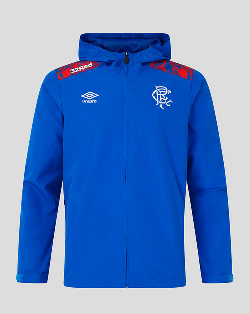 A royal blue hooded zip-up jacket featuring the white Umbro logo on the right chest and the Rangers FC crest on the left chest, with red patterned shoulder panels and '32red' text on the right shoulder, shown against a solid gray background.