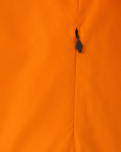 Close-up of a bright orange garment or fabric surface with a vertical seam and a small dark zipper pull near the center.